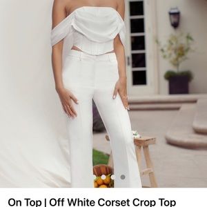 Club L London off white corset crop top with draped off the shoulders sleeves.